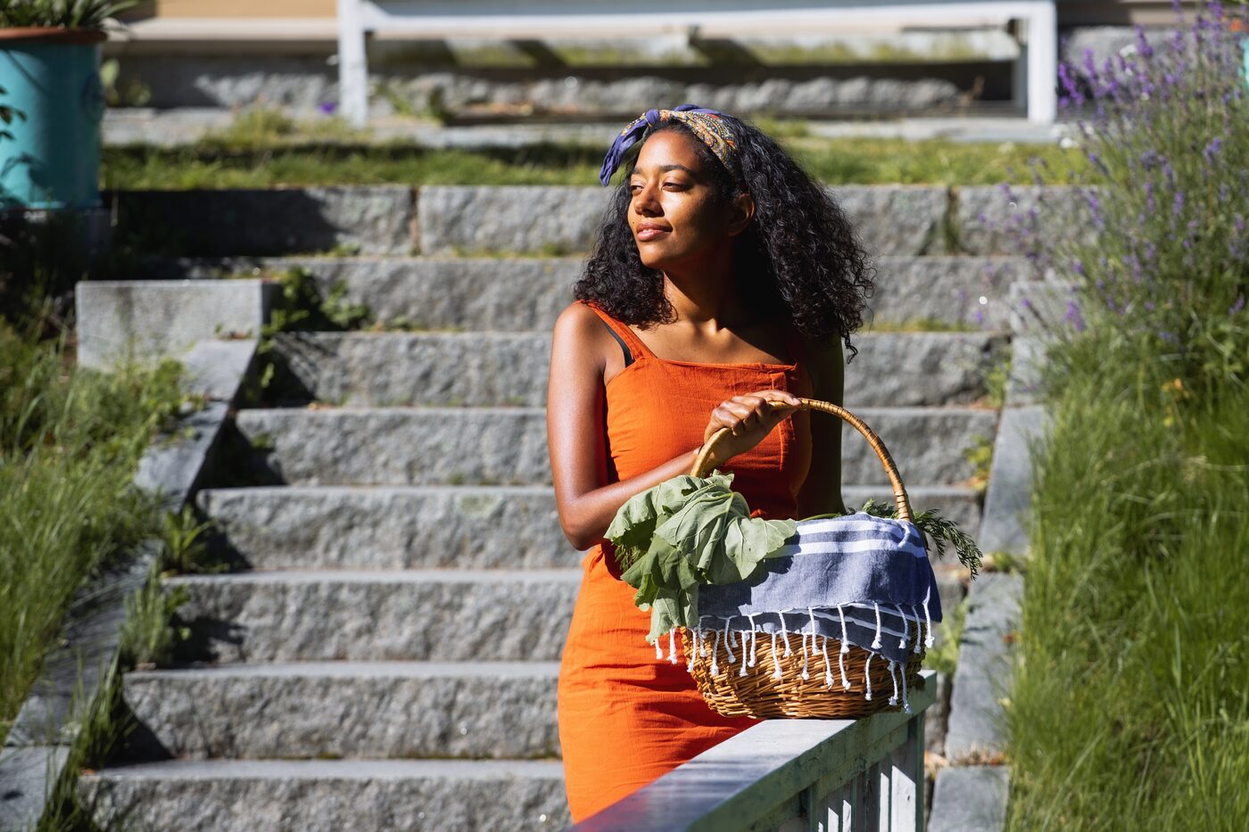 Telma carrying a basket of fresh greens
